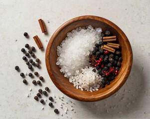 Wooden bowl filled with coarse salt peppercorns cinnamon sticks star anise and red berries
