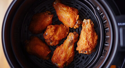 Crispy chicken wings in air fryer, golden brown and delicious, perfect for tasty meal or snack. Enjoy savory flavor and crunchy texture