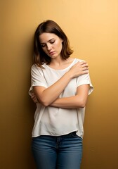 A young woman holding her own arm, symbolizing loneliness
