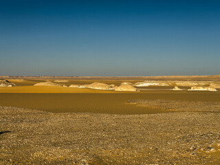 White rock formations and sand dunes in Egypt's White Desert, natural desert landscape	