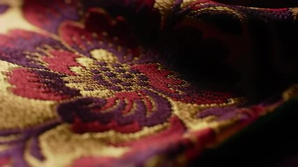 Floral textile with red, purple, and gold embroidery detail closeup - Powered by Adobe