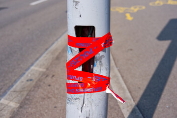 Broken pole with securing of evidence sticker at Swiss city of Zürich on a sunny spring day. Photo...
