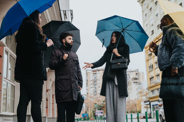 A group of individuals standing in an urban setting, engaging in a lively conversation under...