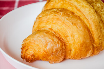 Delicious fresh croissant close up