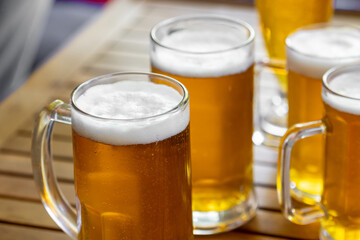 Mugs of light beer in a glass on the table
