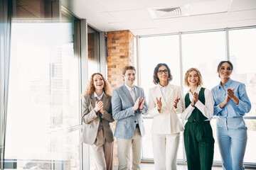 Professional group of coworkers applauding in the office, showcasing teamwork, collaboration, and...