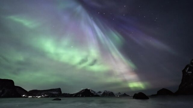Full-sky auroras at Haukland Beach in Lofoten, Norway - tilt up
