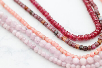 Close-up of Colorful Faceted Gemstone Beads: Red Spinel, Ruby, Rhodochrosite, and Kunzite