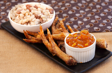 Fried chicken feet served with Chakalaka and samp