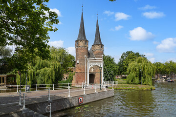 The iconic Oostpoort (Eastern Gate) in Delft, a picturesque medieval landmark with its twin spires,...