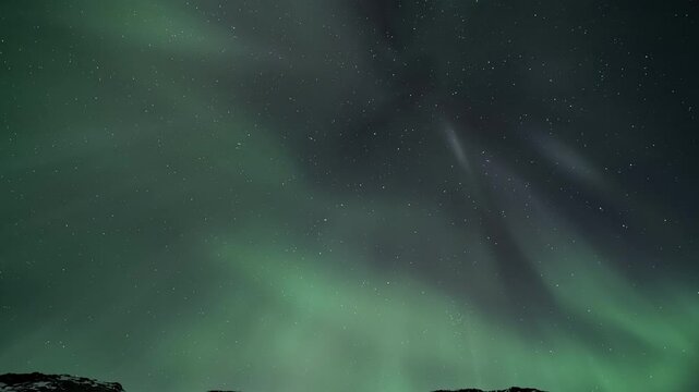 Aurora borealis above a snowy mountains