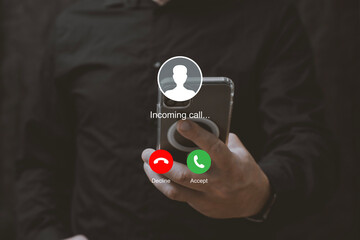 Man holding smartphone with incoming call interface screen. Close-up of hands holding mobile phone with call accept and decline buttons on display.