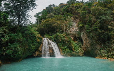 Close Scenic Wide View of Kawasan Falls Jungle Waterfall and Turquoise River in Cebu, Philippines