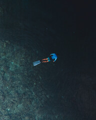 Top view bird's eye scuba divers in between the Vibrant Reefline and turquoise waters of Pescador Island scuba spot  &ndash; Moalboal, Cebu, Philippines
