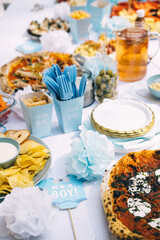 Delicious spread for a baby shower celebration featuring various foods and decorations