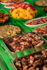 Filipino food buffet with pork and fish, seafood, noodles and vegetables for tour tourist in El Nido, Palawan, Philippines
