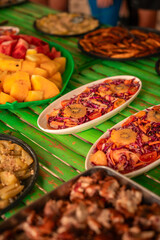 Filipino food buffet with pork and fish, seafood, noodles and vegetables for tour tourist in El Nido, Palawan, Philippines
