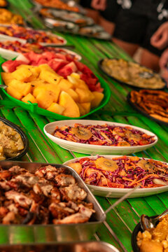Filipino food buffet with pork and fish, seafood, noodles and vegetables for tour tourist in El Nido, Palawan, Philippines
