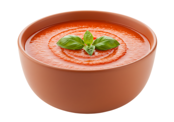 A bowl of tomato soup topped with three fresh basil leaves centered on a black background