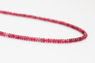 Red Spinel Faceted Rondelle Beads on White Background

