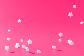 Star and Heart shaped Ramune Particles on pink background
