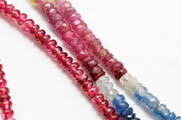 Red Spinel and Sapphire Faceted Beads on White Background

