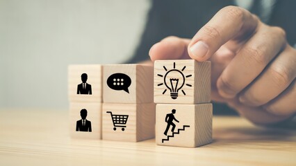 Business development and idea generation with wooden blocks stacked by hand