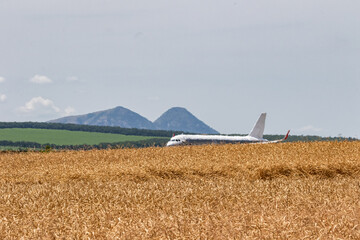 A passenger plane takes off on a very hot summer day