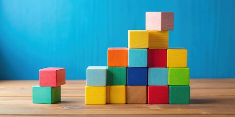 Colorful wooden blocks stacked high on a table