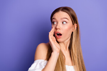 Excited young woman expressing surprise while gesturing on a bold purple background showcasing glamour and charm