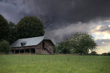 Traditional Normandy Barn Under a Stormy Sky