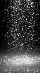 Obraz premium A mesmerizing shower of silver glitter gently flutters in the darkness crafting a luxurious atmosphere that enchants viewers suitable for artistic projects and chic party themes.