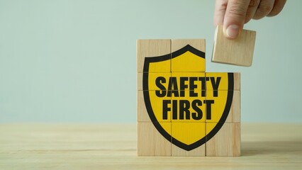 Blocks display the phrase Safety First with a hand about to put a block on top