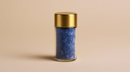 Luxury glass salt grinder with gold lid, filled with blue salt, elegant and modern kitchen accessory