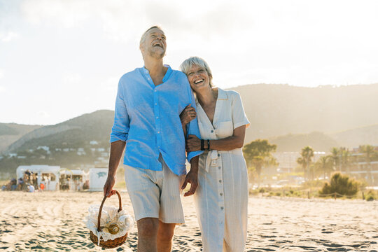 Beautiful happy senior couple dating at the seaside during summertime