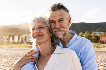 Beautiful happy senior couple dating at the seaside during summertime