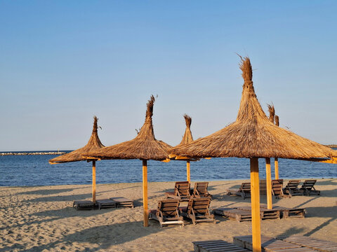 Umbrellas and sun loungers on the beach at the Black Sea. In Mamaia, Constanta