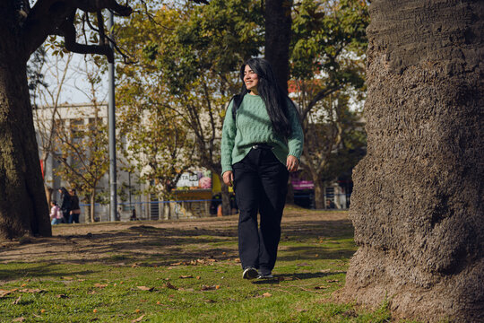 happy young woman walking in the park