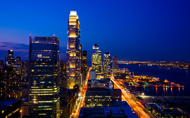 Fototapeta premium USA, New York City, New York, Manhattan, Aerial view of illuminated skyline at night.