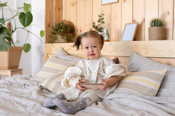 Little girl on bed in bedroom