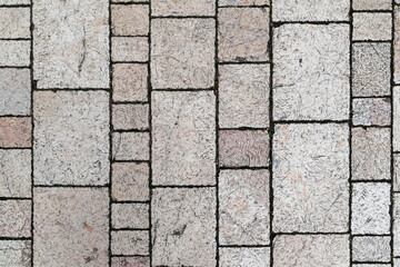 Abstract beige stone brick wall texture with patterned tiles