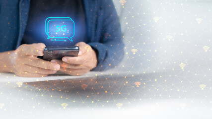 Hand holding smartphone with 5G wireless communication icon, high-speed internet network, modern digital technology for fast data connection.