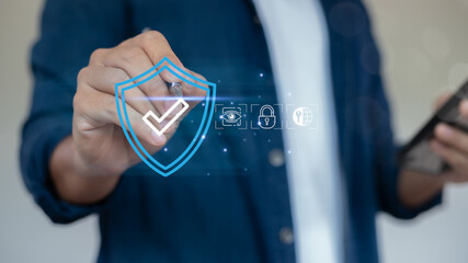 Hand pressing shield icon with check mark, cybersecurity concept, data protection, privacy, and...