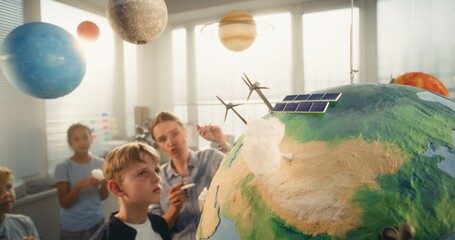 Environmental Science Lesson: Female Teacher Educating Renewable Energy to Team of Smart Kids in...