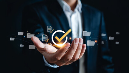 Businessman holding a glowing checkmark and document icons symbolizing successful digital data management and workflow approval