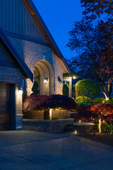 Entrance of luxury house with nice spring blossom landscape at night in Vancouver, Canada, North...