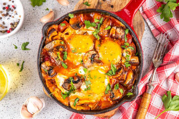 Mushroom Shakshuka. Tasty breakfast shakshuka with baked fried eggs, vegetables - tomato, onions, bell pepper and a lot of champignon mushrooms