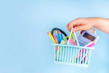 Back to school sale and shopping concept. Variety of school stationery in shopping basket pencils,...
