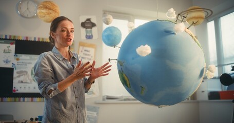 STEM Class: Female School Teacher Educating Science and Renewable Energy Sources Using Model of...