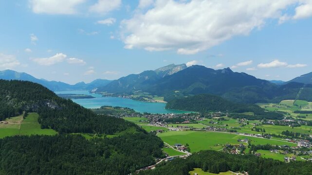 Drone of Strobl Town and Lake Wolfgangsee surrounded by stunning Austrian Alpine peaks, establishing over